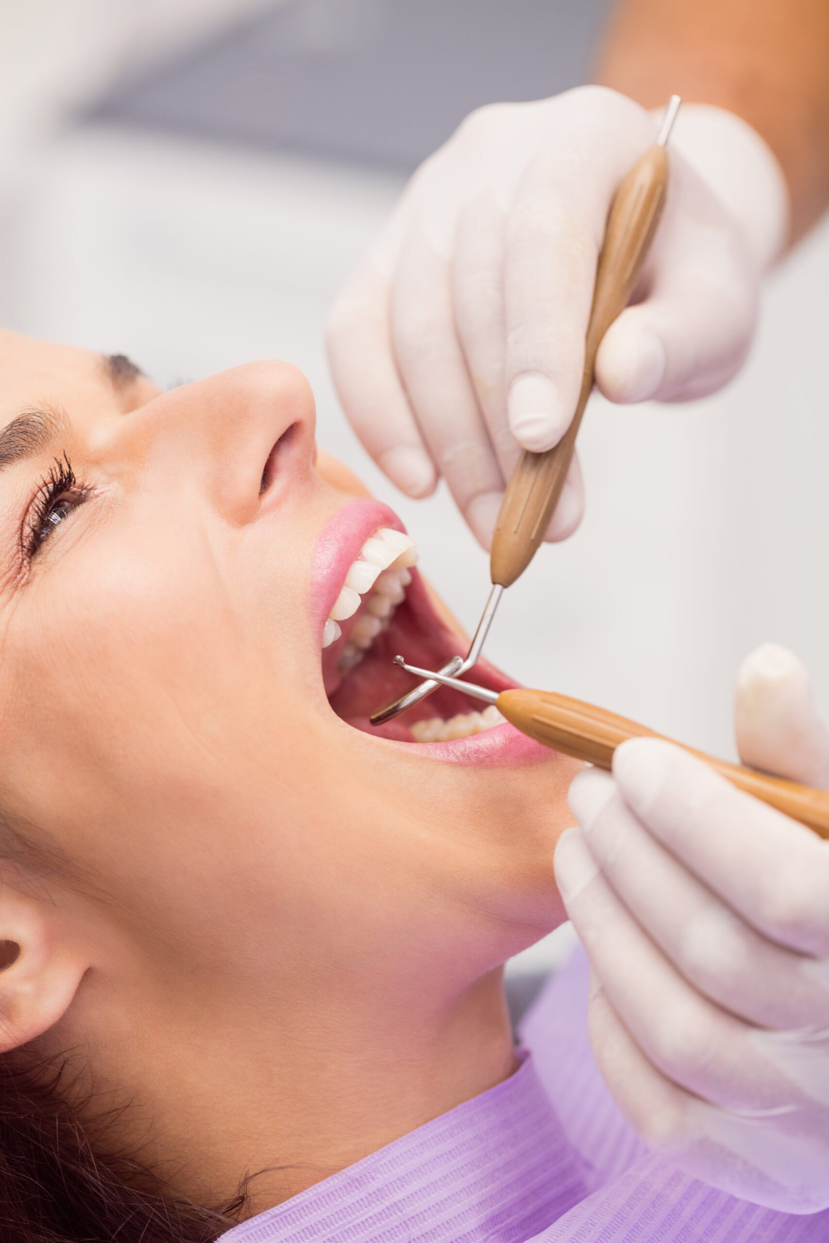 Close up of dentist examining female patient teeth